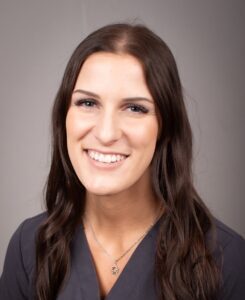 closeup headshot of Allison Perri, R.T.(T) in gray scrubs